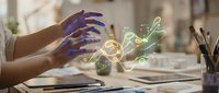 Young woman hands creating magical glowing digital art elements with colorful light effects floating above workspace desk for creative design projects.