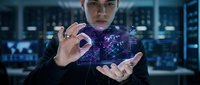 Young Caucasian businessman in dark suit manipulating holographic digital network interface in modern server room data center technology concept.