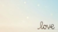 Romantic love word written in elegant rope lettering on soft pastel gradient background with floating bokeh lights for wedding invitations.