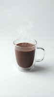 Double-walled glass mug filled with hot chocolate drink isolated on white background for beverage and cafe design projects.