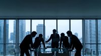 Business team silhouettes meeting in modern office conference room with city skyline view through large windows for corporate presentations.