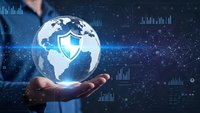 Businessman holding holographic globe with security shield icon representing global cybersecurity and data protection in digital technology environment.