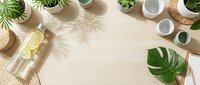 Overhead view of potted succulents and monstera plants arranged on beige wooden surface with natural sunlight shadows, ideal for home decor and gardening content.