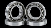 Pair of industrial ball bearings with steel rings and ball cage isolated on transparent background, ready for design use in technical illustrations, product mockups, engineering graphics, and print-on-demand materials.