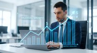 Professional businessman analyzing financial data with holographic growth charts and market analytics in modern office environment.