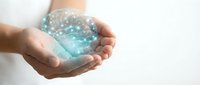 Hands holding glowing digital brain with network connections representing artificial intelligence, machine learning, and neural networks for technology concepts.