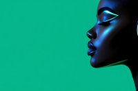 Side profile of woman with glowing makeup in neon blue light against vibrant green background, dramatic contrast highlighting facial features and glossy lips.