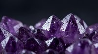 Purple amethyst crystal cluster with sparkling faceted gemstones on dark background for jewelry design and spiritual healing concepts.