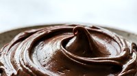 Rich creamy chocolate frosting swirl with glossy texture for baking desserts cakes cupcakes pastries confectionery culinary food photography commercial use.