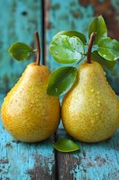 Fresh ripe yellow pears with green leaves and water droplets on rustic turquoise wooden background for healthy eating and organic fruit concepts.