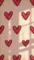 Red hearts with delicate line details arranged on soft pink background with natural window light shadows, suitable for Valentine's Day, love, romance, and greeting card designs.