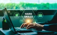 Professional businessman typing on laptop with hard skills technology icons overlay representing technical competencies and expertise development.