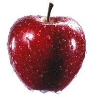 Fresh red apple with water drops on white background, isolated macro shot showing glossy skin texture and natural stem for food and health concepts.