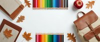 Autumn school supplies with colorful pencils, leather backpack, notebooks and maple leaves arranged on white background for back to school season.