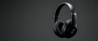 Black over-ear headphones with padded ear cups and adjustable headband isolated on dark background, suitable for music, audio equipment, and technology product design.