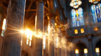 Sunbeams pierce through incense smoke in gothic cathedral interior, creating ethereal light rays among stone columns and stained glass windows. Religious atmosphere.