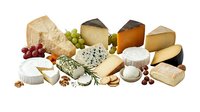 Assorted gourmet cheese selection with grapes nuts and herbs isolated on white background for culinary design and food photography projects.