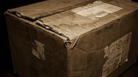 Old weathered cardboard box with torn edges and vintage shipping labels creates nostalgic storage and delivery concept for antique collectors.