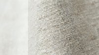 Natural linen fabric texture with woven fibers in neutral beige tones, close-up detail showing organic textile pattern for interior design and crafting projects.