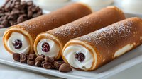 Freshly baked cannoli filled with sweet ricotta cream and dark cherries, dusted with powdered sugar, served on white plate with chocolate chips decoration.