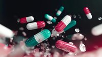 Colorful medical capsules and pills floating in motion with dynamic blur effect against dark background for healthcare and pharmaceutical concepts.