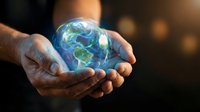 Hands gently holding glowing Earth globe with continents visible, symbolizing environmental protection, sustainability and global responsibility concept.