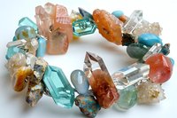 Colorful gemstone bracelet with mixed natural stones including turquoise, amber, quartz and agate beads on white background for jewelry design projects.