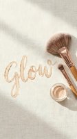 Makeup brushes and shimmer cosmetics arranged with glow text on neutral fabric background for beauty and cosmetics industry marketing.