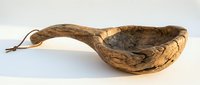 Rustic wooden ladle with natural grain patterns and leather cord handle isolated on white background for kitchen decor and culinary design projects.