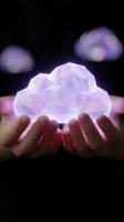 Hands holding glowing purple geometric cloud with polygonal structure against dark background for technology and data storage concepts.