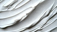 Abstract white wavy textured surface with diagonal flowing lines and subtle shadows creating dynamic relief pattern. Minimalist architectural background for modern design.
