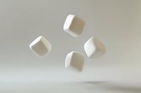 Floating white sugar cubes suspended in air against neutral background, creating minimalist composition with soft shadows and clean aesthetic appeal.