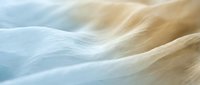 Soft flowing waves of cream and blue fabric create an abstract composition with gentle curves and natural texture, suitable for backgrounds and design projects.