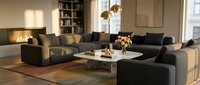 Modern living room with modular black sectional sofa, white coffee table, pendant lighting, and warm wood flooring for interior design and home decor projects.