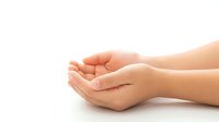 Open cupped hands in protective gesture on white background, symbolizing care, support and offering help in healthcare and wellness concepts.