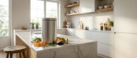 Modern minimalist kitchen interior with marble island, white cabinets, wooden shelves and fresh vegetables for contemporary home design and cooking lifestyle.