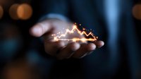 Glowing stock market chart floating above businessman hands in dark environment with bokeh lights, representing financial growth and investment success.