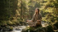 Young woman meditating in peaceful forest setting by flowing stream. Serene outdoor yoga practice surrounded by lush green nature and golden sunlight.