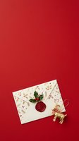 Festive envelope with red wax seal, holly leaves, and gold reindeer ornament on crimson background for holiday greeting cards and seasonal marketing materials.