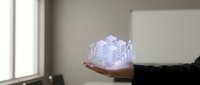 Businessman holding holographic cube with digital network connections floating above palm in modern office environment for technology presentations.