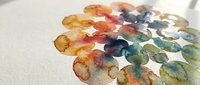 Watercolor paint circles in vibrant colors creating artistic palette on textured paper for creative projects and design work.