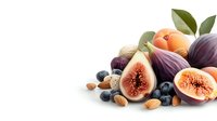 Fresh ripe figs cut in half with blueberries, almonds, apricots and green leaves arranged on white background, isolated food composition.