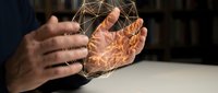 Male hands holding glowing digital brain wireframe, representing artificial intelligence, neural networks, and cognitive technology innovation for business and tech concepts.