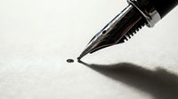 Close-up of elegant fountain pen nib touching paper surface with ink dot, creating dramatic shadow. Professional writing instrument for business documents.