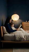 Mother and young son reading book together in cozy bedroom with warm lamp light creating intimate bedtime story moment for family bonding and education.