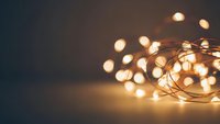 Warm glowing string lights with soft bokeh effect creating cozy ambient atmosphere for holiday decorations and festive celebrations.