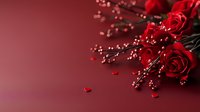 Red roses bouquet with golden beads and small hearts on burgundy background for romantic occasions and Valentine's Day celebrations.