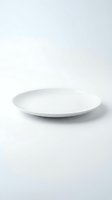 Empty white ceramic plate on clean white background for food presentation and culinary design projects.