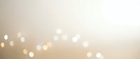 Soft beige bokeh background with warm golden light spots creating dreamy atmosphere for wedding invitations, greeting cards and elegant design projects.