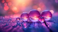 Magical glass spheres reflecting sunset sky with pink and purple bokeh lights on wet surface, creating dreamy macro photography effect.